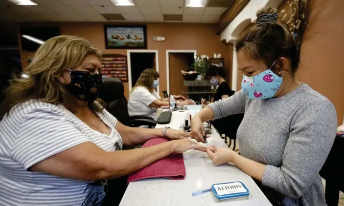  ?? Photograph: Rich Pedroncell­i/AP ?? Beatrice Urquidez gets her nails done by Thuy Le, owner of the Nail Tech salon in the Yuba Sutter Mall in Yuba City, California.