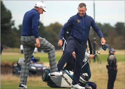  ??  ?? Ian Poulter and Lee Westwood enjoy a socially- distanced greeting while Scott Jamieson ( below) plays on