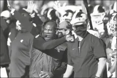  ?? ASSOCIATED PRESS ?? MICHIGAN STATE HEAD COACH MEL TUCKER pumps his fist after the team defeated Michigan in a game on Saturday in Ann Arbor, Mich.