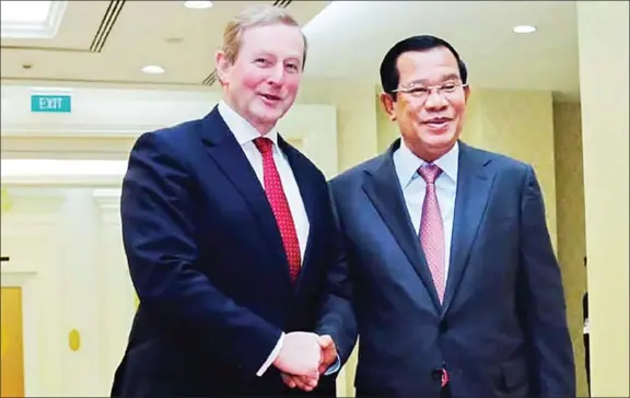  ?? HUN SEN’S FACEBOOK PAGE ?? Prime Minister Hun Sen shakes hands with Irish member of parliament Enda Kenny at the Peace Palace in Phnom Penh on Saturday.