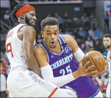  ?? Nell Redmond The Associated Press ?? Findlay Prep product P.J. Washington tries to go to the basket against Rockets forward DeMarre Carroll in the first half of the Hornets’ 108-99 win Saturday.