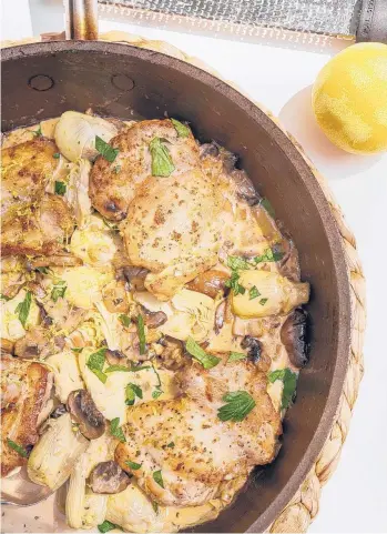  ?? KRISTEN MENDIOLA/THE DAILY MEAL PHOTOS; SHANNON KINSELLA/FOOD STYLING ?? Supper club-inspired chicken with artichokes and cream makes a luxurious — yet easy — weekday meal.