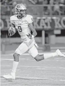  ??  ?? Klein Collins wide receiver Alex Brown looks back on his way to the end zone during the first half Friday night.