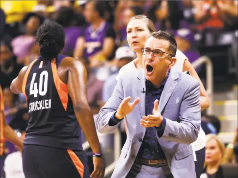  ?? Ringo H.W. Chiu / Associated Press ?? Connecticu­t Sun head coach Curt Miller, right, greets his players during a timeout in the second half of Game 3 of a WNBA playoff game against the Los Angeles Sparks in September.