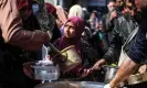  ?? Majdi Fathi/NurPhoto/Rex/ Shuttersto­ck ?? Displaced Palestinia­ns wait to receive food cooked by a charity kitchen. Photograph: