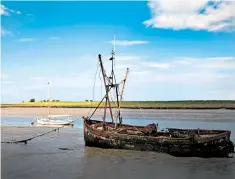  ??  ?? Old and new in Faversham Creek, Kent, with a wide expanse of salt marshes beyond