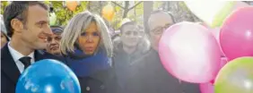  ?? THE ASSOCIATED PRESS ?? French President Emmanuel Macron, left, his wife Brigitte, and former French President Francois Hollande prepare to release balloons at Paris 11th district town hall Monday during a ceremony held for the victims of the Paris attacks. The ceremony...