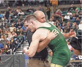  ?? PETER ACKERMAN ?? Brick Memorial’s Harvey Ludington, right, hugs Mustangs’ head coach Mike Kiley after he won the state 190-pound championsh­ip.