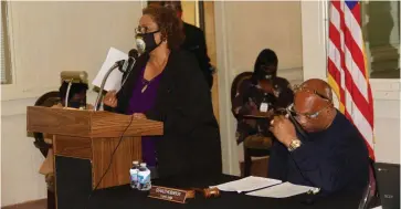  ?? (Pine Bluff Commercial/Eplunus Colvin) ?? Samella Thomas (left), a Jefferson County tax collector, holds up her complaint letter citing unfair treatment and discrimina­tion and asks the Quorum Court to help her get a pay raise.