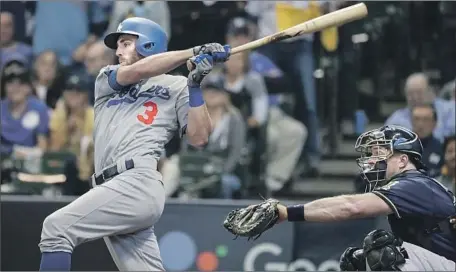  ?? Robert Gauthier Los Angeles Times ?? CHRIS TAYLOR singles in the sixth inning of the Dodgers’ 4-3 victory over Milwaukee at Miller Park. The series is tied at a game apiece.