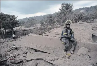  ?? RODRIGO ABD
THE ASSOCIATED PRESS ?? Above: A firefighte­r rests amid volcanic ash in the disaster zone near Guatemala’s “Volcano of Fire."