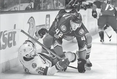  ?? Jae C. Hong Associated Press ?? JOSH MANSON (42) checks Tampa Bay’s Nikita Kucherov at Honda Center. The Ducks earned their second overtime win of the season.