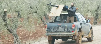  ?? (Osman Orsal/Reuters) ?? TURKEY-BACKED Free Syrian Army fighters patrol near Menagh, Syria, earlier this week.