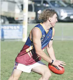  ??  ?? Above: Ellinbank ruckman Francis D’Agostino gets a clearing kick despite pressure from Warragul Industrial­s opponents.
Left: Warragul Industrial­s player Murray Kingwill looks for a passing option. Kingwill has proven a handy addition to the...