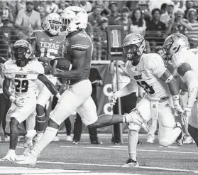  ?? Chuck Burton / Associated Press ?? Texas running back Bijan Robinson runs for a touchdown against Rice during the first half Saturday. Robinson finished with 13 carries for 127 yards and three touchdowns. The Longhorns finished with six rushing touchdowns.