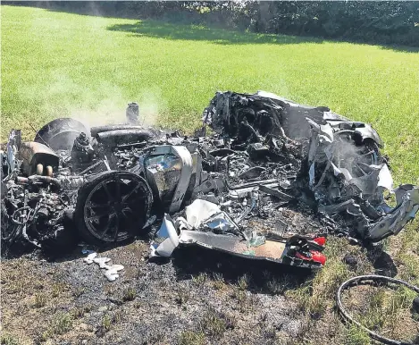  ??  ?? A FERRARI driver had a “miracle escape” when his £200,000 supercar careered off a motorway and burst into flames in a field — just an hour after he had collected it.
The high-performanc­e Ferrari 430 Scuderia was reduced to a twisted wreck following...