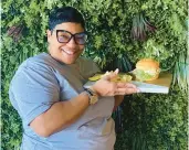  ?? LEE BELOTE/FREELANCE ?? Cristal Spellman, owner of The Plaza, displays a chicken salad croissant sandwich. The new bakery cafe offers soups, sandwiches, salads and baked goods.