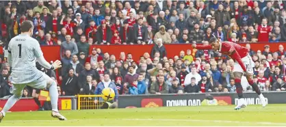  ?? ?? BELOW: Marcus Rashford scores in Manchester United’s 3-0 win over Leicester City this past weekend to ensure the Red Devils stay close to Manchester City and Arsenal at the top of the Premier League.