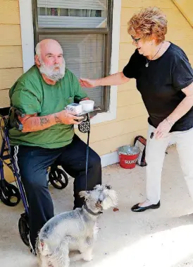  ?? [PHOTO BY PAUL HELLSTERN, THE OKLAHOMAN] ?? Kaye Poos greets Roland, one of her clients.