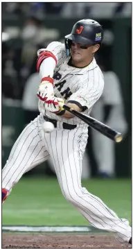  ?? (AP/Eugene Hoshiko) ?? St. Louis Cardinals outfielder Lars Nootbaar, playing for Japan, hits a single during a World Baseball Classic quarterfin­al game against Italy last month. Nootbaar became an unlikely internatio­nal star thanks to the WBC.