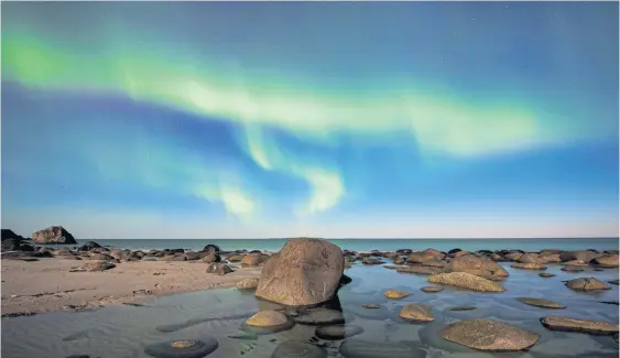  ?? AFP ?? Light fantastic Northern lights illuminate the sky over Uttakleiv beach near Leknes, on the Lofoten Islands, Arctic Norway, on Sunday night.