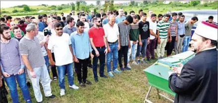  ?? ELVIS BARUKCIC/AFP ?? Migrants from Asian countries attend an Islamic funeral at the Bihac city cemetery on Friday, paying their respects to a fellow migrant from Afghanista­n. Ihsan Udin, 21, drowned in a river on the border between Bosnia and Croatia.