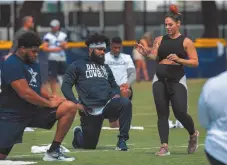  ?? CITIZEN NEWS SERVICE PHOTO ?? Dallas Cowboys offensive tackle La’el Collins, left, and running back Ezekiel Elliott, centre, listen to yoga instructor Stacey Hickman, right, as the team does some flexibilit­y exercises at NFL football training camp, Saturday, July 28, 2018, in Oxnard, Calif.