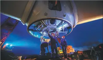  ?? CAI SHUANGRONG / FOR CHINA DAILY ?? Below: Workers inspect the wind turbine blades before hoisting at Unit 19, the first installed unit of the Hongjian Mountain Wind Farm Project in Zhangping, Fujian province, June 26, 2018.