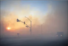  ?? MINDY SCHAUER — STAFF PHOTOGRAPH­ER ?? Wildfire smoke helps create an eerie orange glow along Irvine Boulevard near Alton Parkway in Irvine in October. The West Coast fires hurt air quality worst in September, when the U.S. accounted for 77 of the world’s 100 most polluted cities and towns.