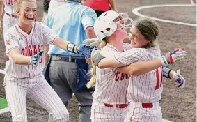  ?? Melissa Phillip / Staff photograph­er ?? Grace Sparks (23) and Trista Brown celebrate after Jordee Wilkins (11) scored Crosby’s game-winning run in the eighth inning of Saturday’s series clincher.