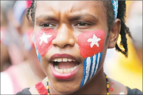  ??  ?? A Papuan student with her face painted with the colors of the separatist ‘Morning Star’ flag shouts slogans during a rally near the presidenti­al palace in Jakarta,
Indonesia on Aug 28. (AP)