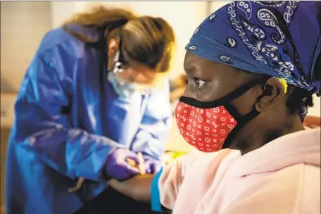  ?? Francine Orr Los Angeles Times ?? LATASHA JAMES, 40, gets a coronaviru­s antibody test at South Central Family Health Center in Los Angeles. Coronaviru­s infections are rising rapidly in L.A. County, and an uptick in related deaths has already begun. Newly implemente­d restrictio­ns may slow the spread.