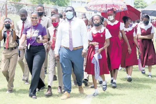  ?? PHOTOS BY NATHANIEL STEWART/ PHOTOGRAPH­ER ?? Dr Marsha Smalling (third left), principal Glenmuir High School in Clarendon, along with her students and staff members make a lap around the field in a bid to bring awareness to lupus.