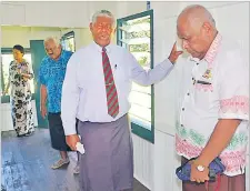  ?? Picture: ELIKI NUKUTABU ?? The Rev Manasa Foiakau (third from left) offers a prayer inside the new teachers quarters at Ballantine Memorial School in Lami.