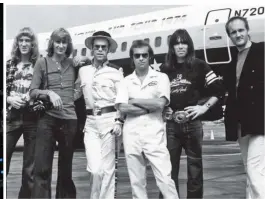  ??  ?? GLAM GIANTS: The Elton John Band with Elton and lyricist Bernie Taupin in front of their 1974 US tour plane. From left: Davey Johnstone, Dee Murray (now deceased), Elton, Bernie, Nigel Olsson and Ray Cooper