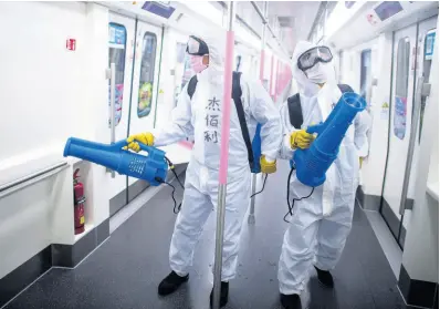  ?? AP PHOTOS ?? In this March 23, 2020 photo released by Xinhua News Agency, workers disinfect a subway train in preparatio­n for the restoratio­n of public transport in Wuhan, in central China’s Hubei province.