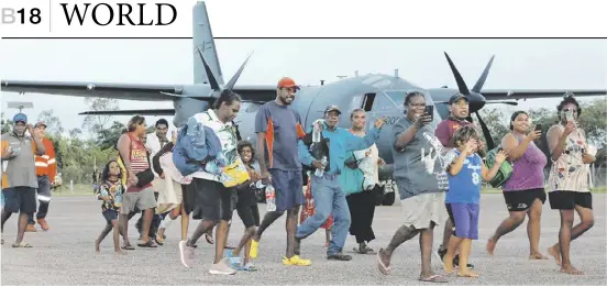  ?? ANDREW EDDIE/AUSTRALIA DEFENCE/AGENCE FRANCE-PRESSE ?? RESIDENTS prepare to board an RAAF C-130J Hercules aircraft at Borroloola airport in the Northern Territory as part of evacuation operations following Tropical Cyclone Megan.