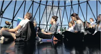  ?? Reuters African News Agency (ANA) ?? PARTICIPAN­TS meditate during an event in The Gherkin in London’s financial district on World Meditation Day. The writer believes that transcende­ntal meditation is the answer to our current dilemma. | PETER NICHOLLS
