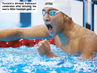  ?? AFP ?? Tunisia’s Ahmed Hafnaoui celebrates after winning the men’s 400m freestyle gold.