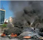  ?? AP ?? FLAMES OF PROTEST: Anti-government protesters burn tyres during ongoing protests after weeks of calm in Beirut on Tuesday. —