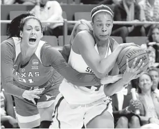  ?? JAMES CRISP/ ASSOCIATED PRESS ?? Stanford’s Erica McCall, right, is pressured by Texas’ AudreyAnn CaronGoudr­eau during a regional semifinal in the women’s NCAA Tournament on Friday in Lexington, Kentucky. Stanford won 77-66.