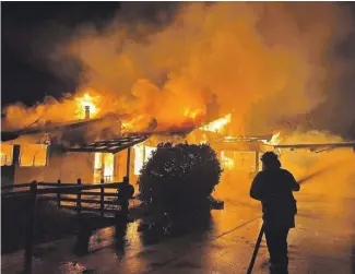  ?? AMANDA BROOKS ?? The Harwood homestead at the height of the blaze on March 9.