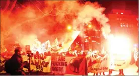  ?? Picture: REUTERS ?? DISENCHANT­ED: Protesters lit flares at a demonstrat­ion against US President Donald Trump.