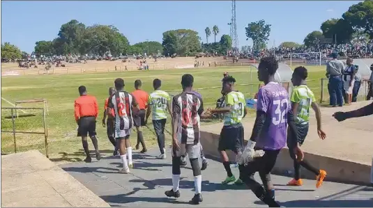  ?? ?? Highlander­s and Bulawayo Chiefs players make their way onto the playing field during a friendly match at Luveve Stadium in Bulawayo on Sunday