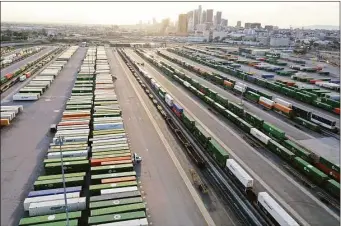  ?? Getty Images ?? Shipping containers and rail cars sit in a Union Pacific Intermodal Terminal rail yard on Nov. 21 in Los Angeles.