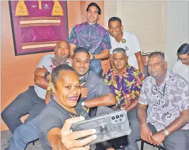  ?? ?? Sophie Ralulu takes a selfie with her male co-workers during clebration­s.