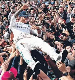  ?? Picture: PA. ?? Lewis Hamilton celebrates his British GP win at Silverston­e last year.