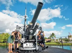  ?? ?? Tourists flock to Hanauma Bay Nature Preserve in Hawaii, main; a family explores the deck of the USS Bowfin, Pearl Harbor, Oahu; and the opulent Iolani Palace. Pearl Harbour picture: Hawaii Tourism Authority/
Tor Johnson