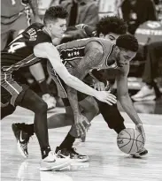  ?? Chris Szagola / Associated Press ?? Philadelph­ia’s Shake Milton, center, goes for the ball against Miami’s Tyler Herro, left, and Gabe Vincent.