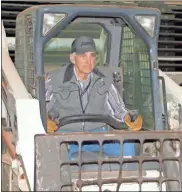  ?? Doug Walker ?? Summervill­e bull breeder Charlie Lowry runs the forklift to build chutes for the bulls at the Three Rivers Invitation­al Bull Riding event in the Forum River Center on Friday and Saturday nights.